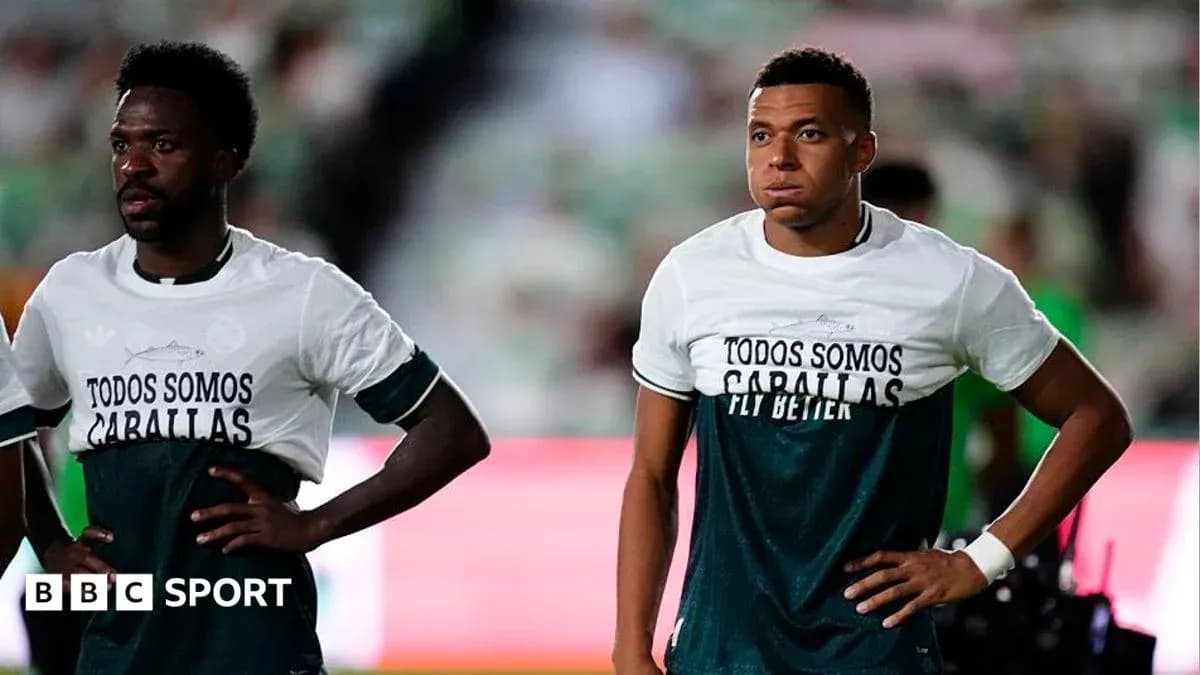 Two players wearing matching warm-up shirts on field Two players wearing matching warm-up shirts on field