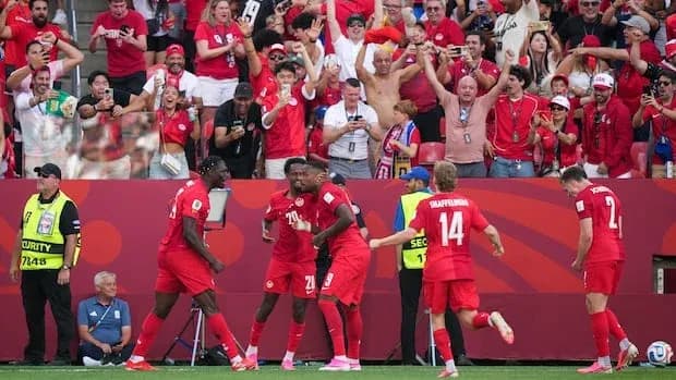 Players celebrating a goal with enthusiastic fans Players celebrating a goal with enthusiastic fans