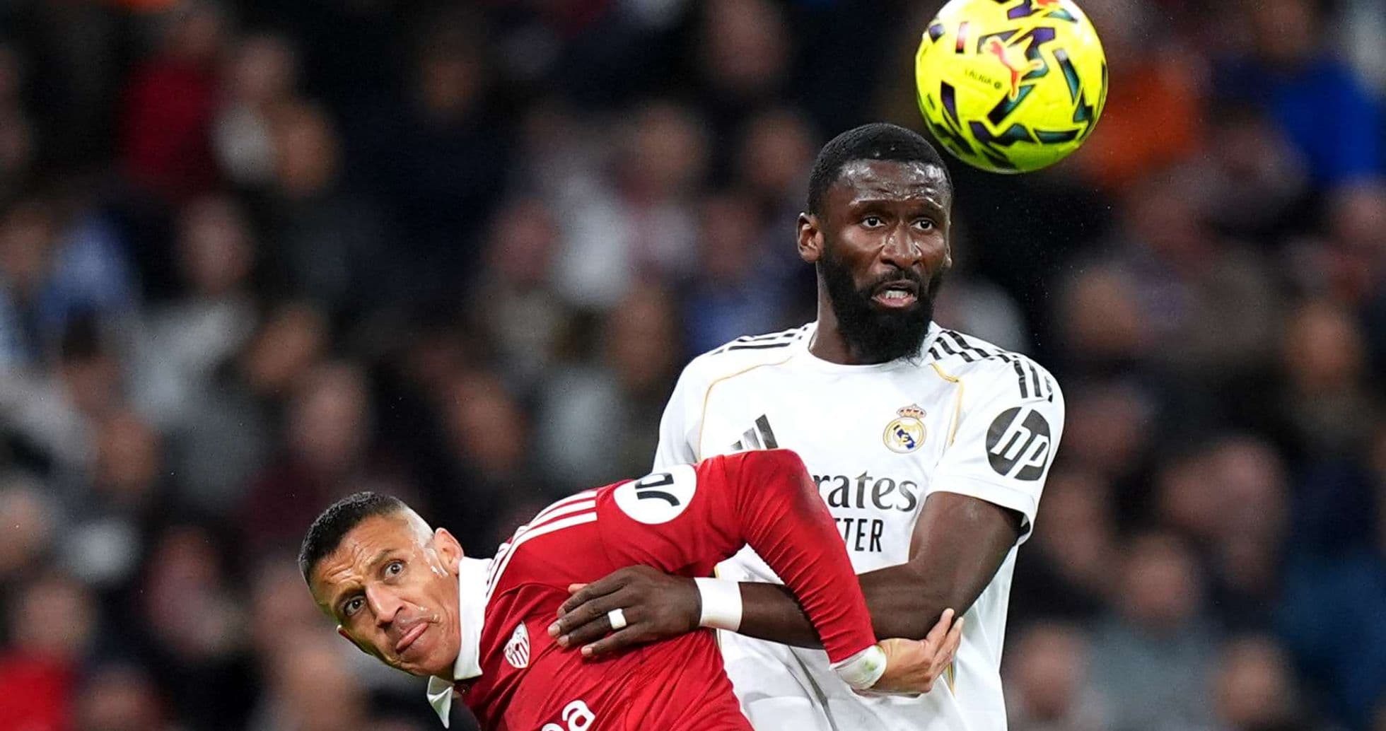 Sevilla player challenged by Real Madrid defender Sevilla player challenged by Real Madrid defender