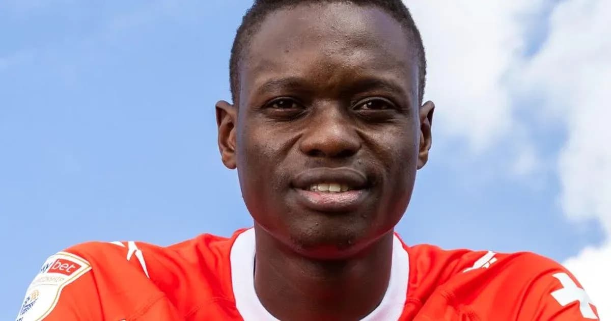 Player in red jersey posing against blue sky Player in red jersey posing against blue sky