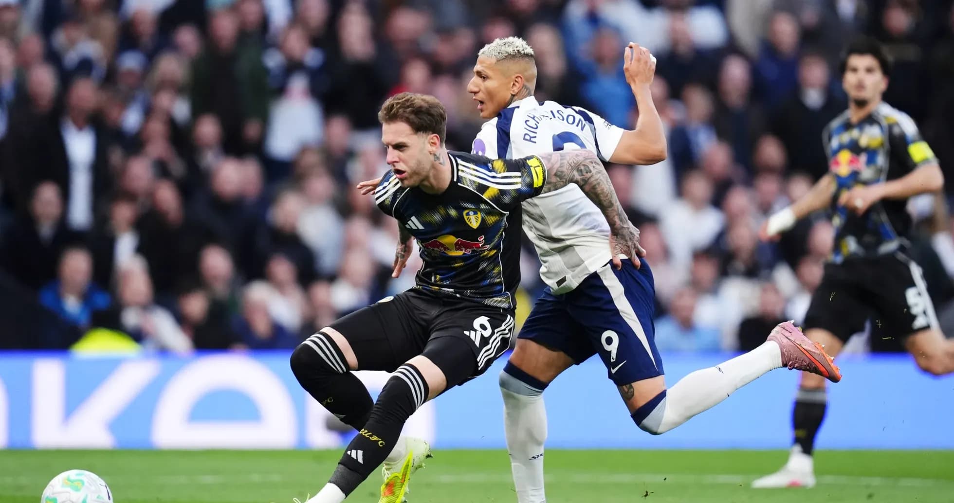 Leeds player challenged by Tottenham player Leeds player challenged by Tottenham player
