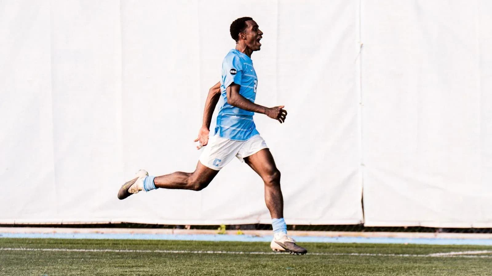 Player celebrating a goal while running on field Player celebrating a goal while running on field