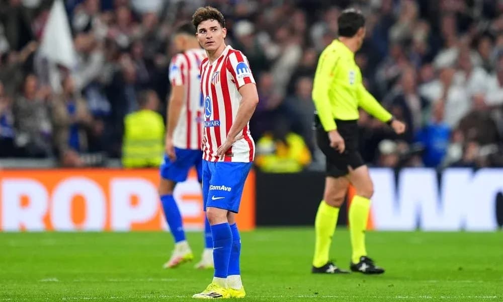 Atletico Madrid player looking dejected on the pitch Atletico Madrid player looking dejected on the pitch