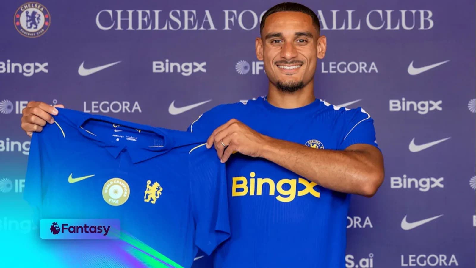 Player holding Chelsea jersey during announcement event Player holding Chelsea jersey during announcement event