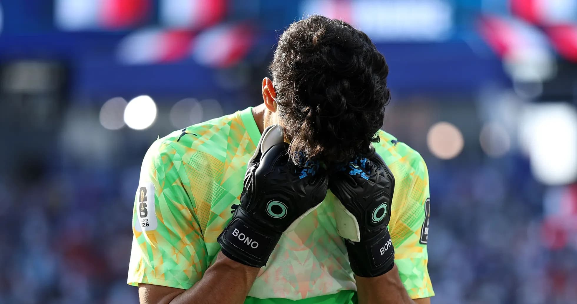 Goalkeeper holding head with gloves on field Goalkeeper holding head with gloves on field