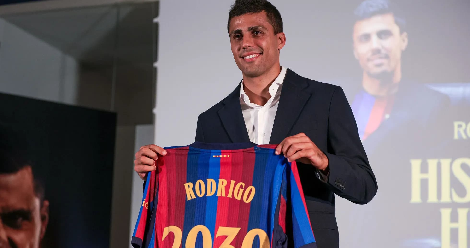 Player holding FC Barcelona jersey at presentation Player holding FC Barcelona jersey at presentation