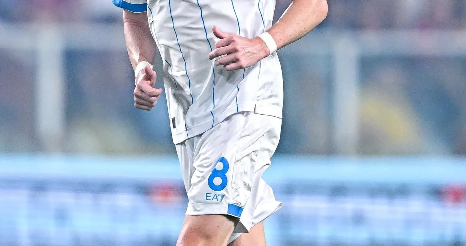 Player wearing Napoli jersey running on the field Player wearing Napoli jersey running on the field