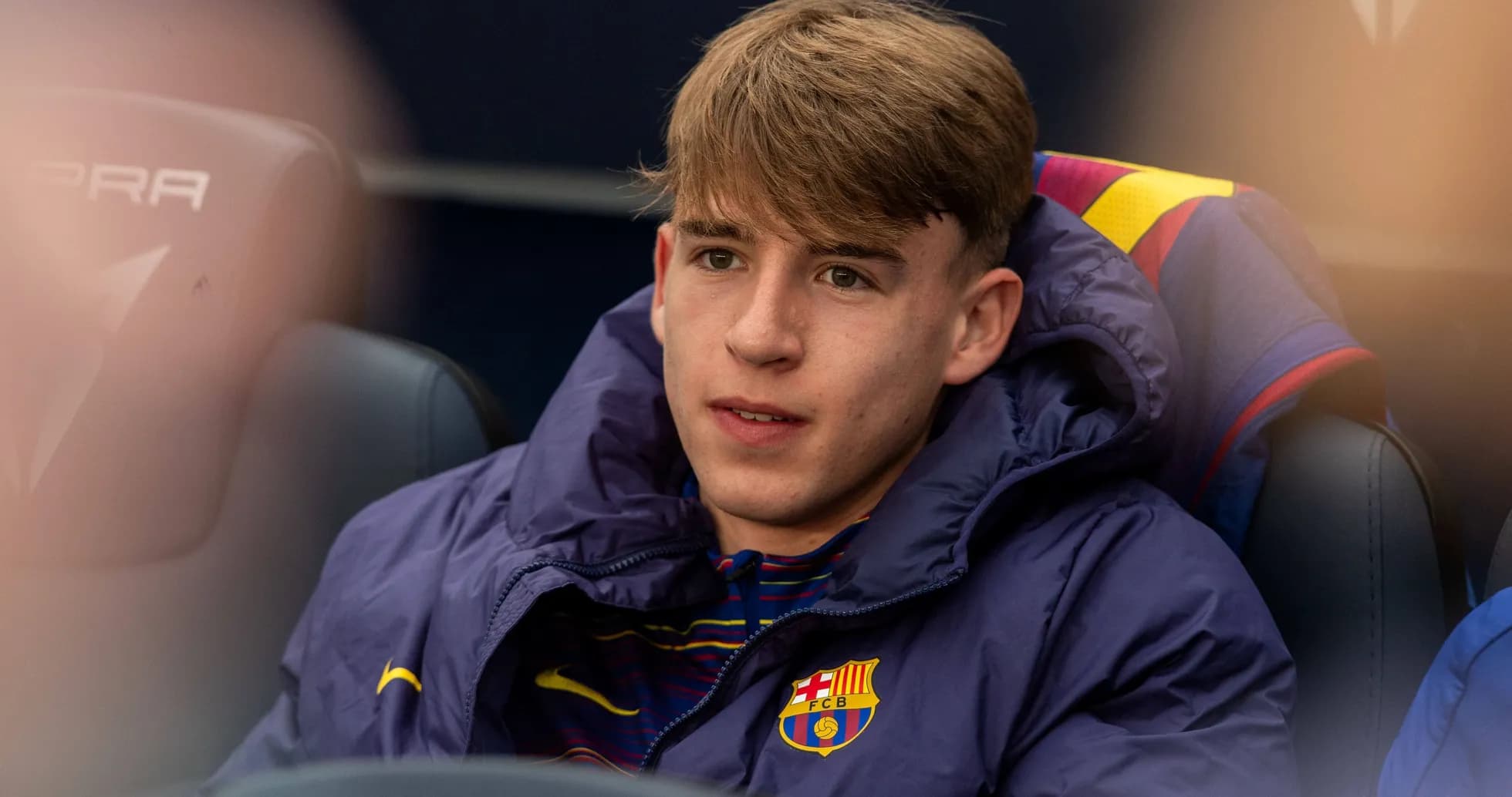 Young player seated on bench during match Young player seated on bench during match