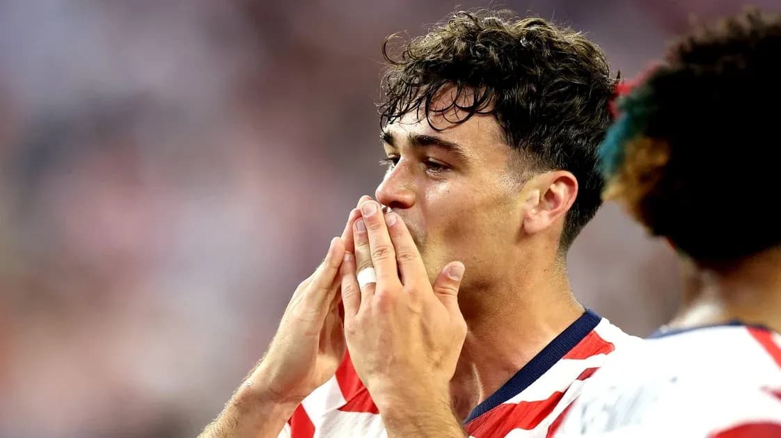 Player celebrating with hands to mouth after match Player celebrating with hands to mouth after match