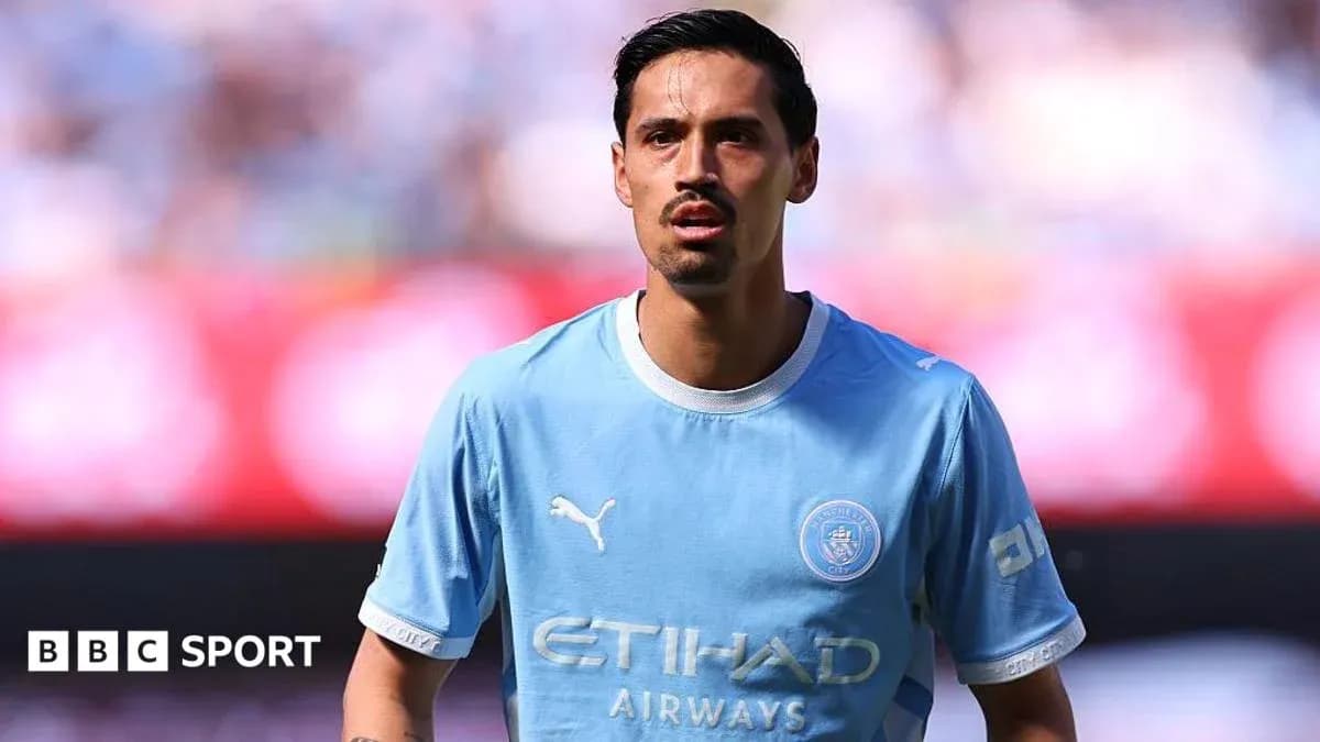 Player in light blue Manchester City kit on pitch Player in light blue Manchester City kit on pitch