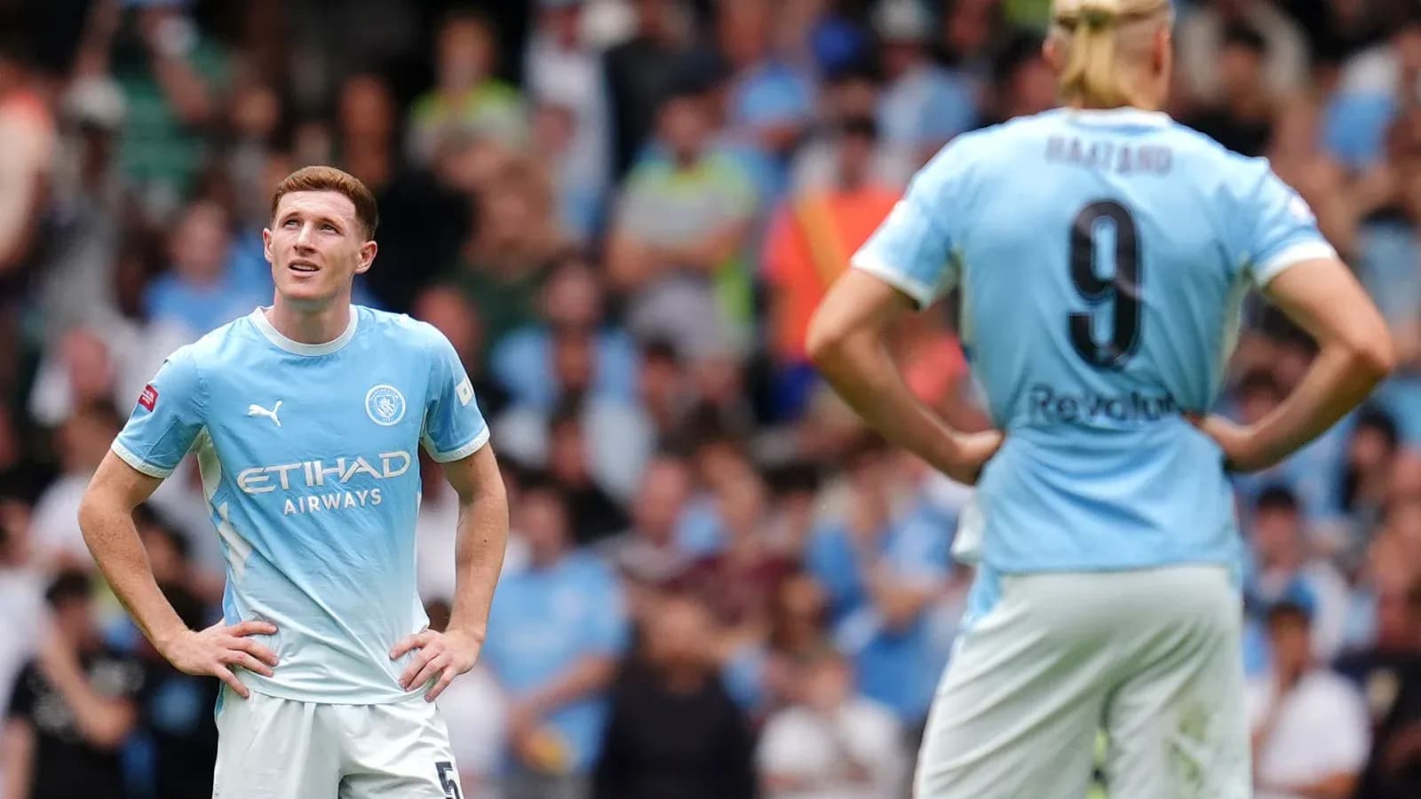 Two Manchester City players on the pitch during match Two Manchester City players on the pitch during match