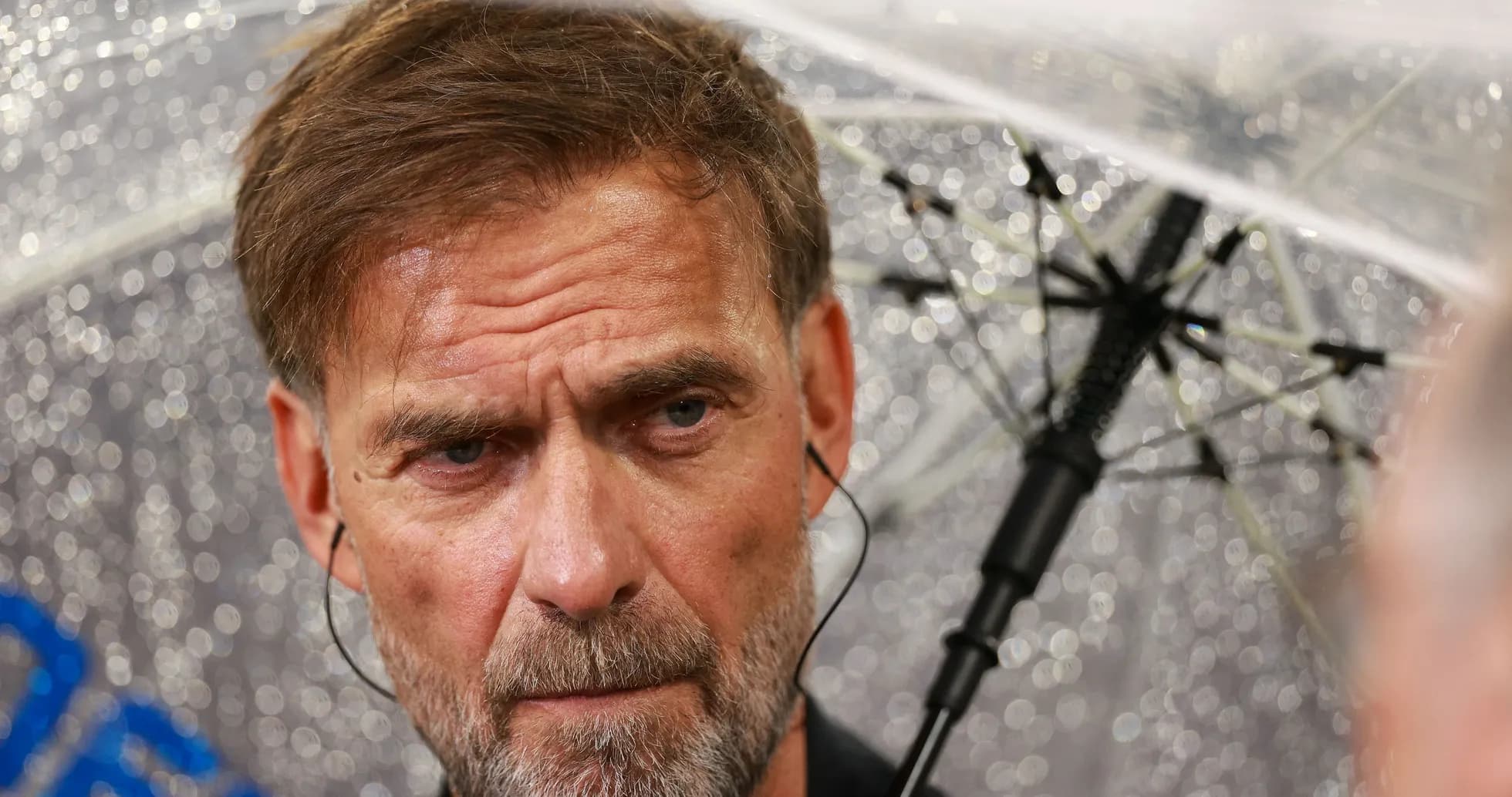 Manager under an umbrella during press conference Manager under an umbrella during press conference