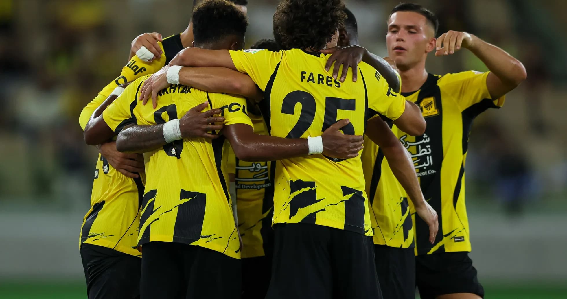 Players celebrating a goal in team jerseys Players celebrating a goal in team jerseys