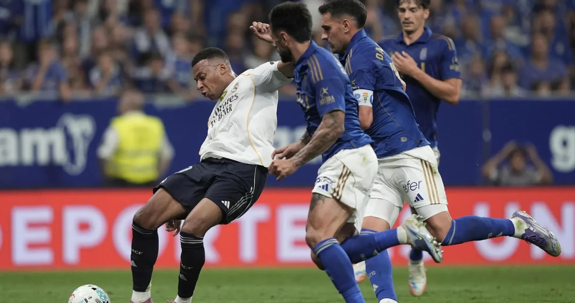 Real Madrid player tackled by Oviedo defenders Real Madrid player tackled by Oviedo defenders