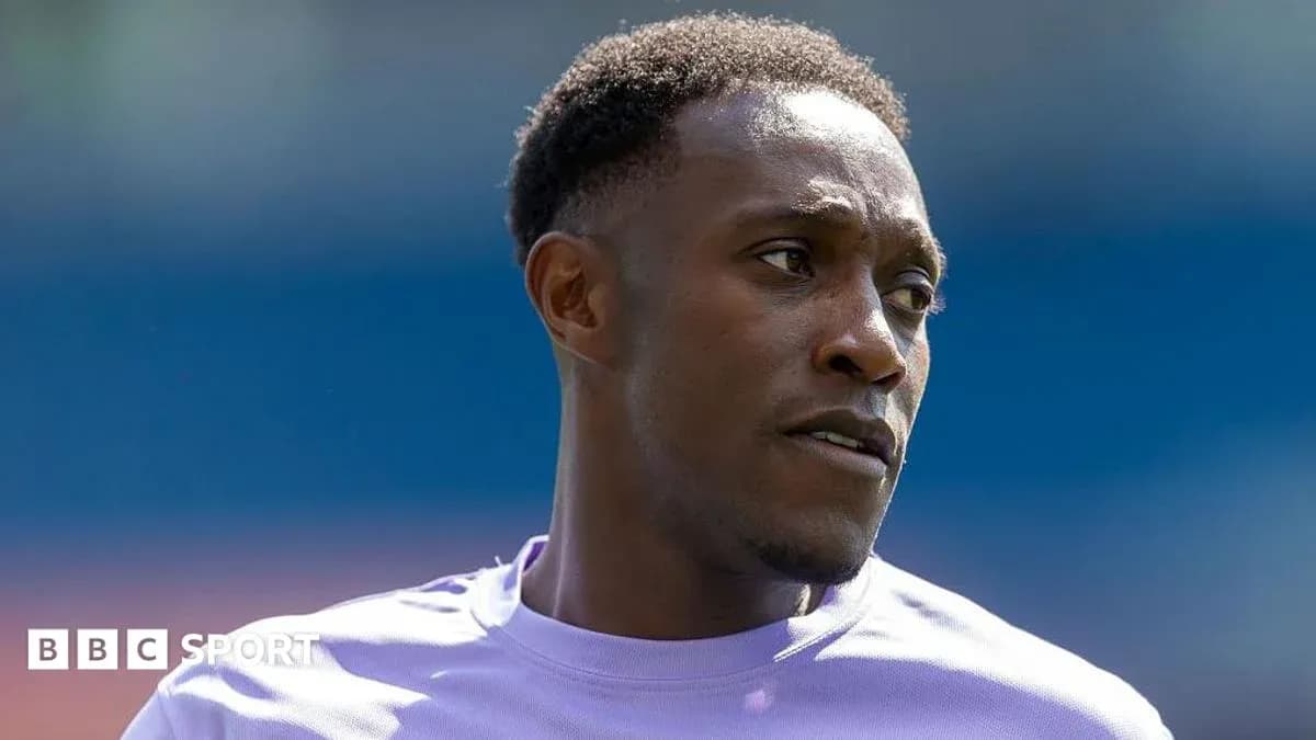 Football player wearing a purple jersey during warm-up Football player wearing a purple jersey during warm-up