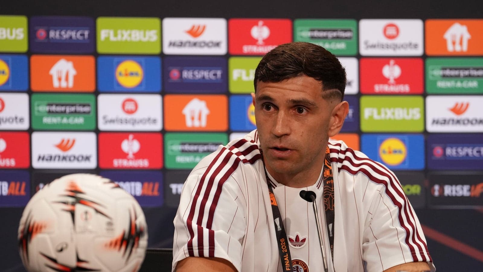 Player speaking at press conference with soccer ball Player speaking at press conference with soccer ball