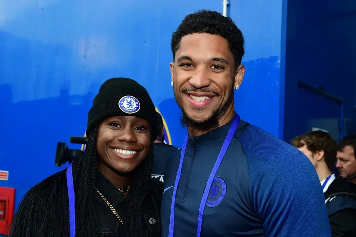 Two individuals smiling in Chelsea apparel Two individuals smiling in Chelsea apparel