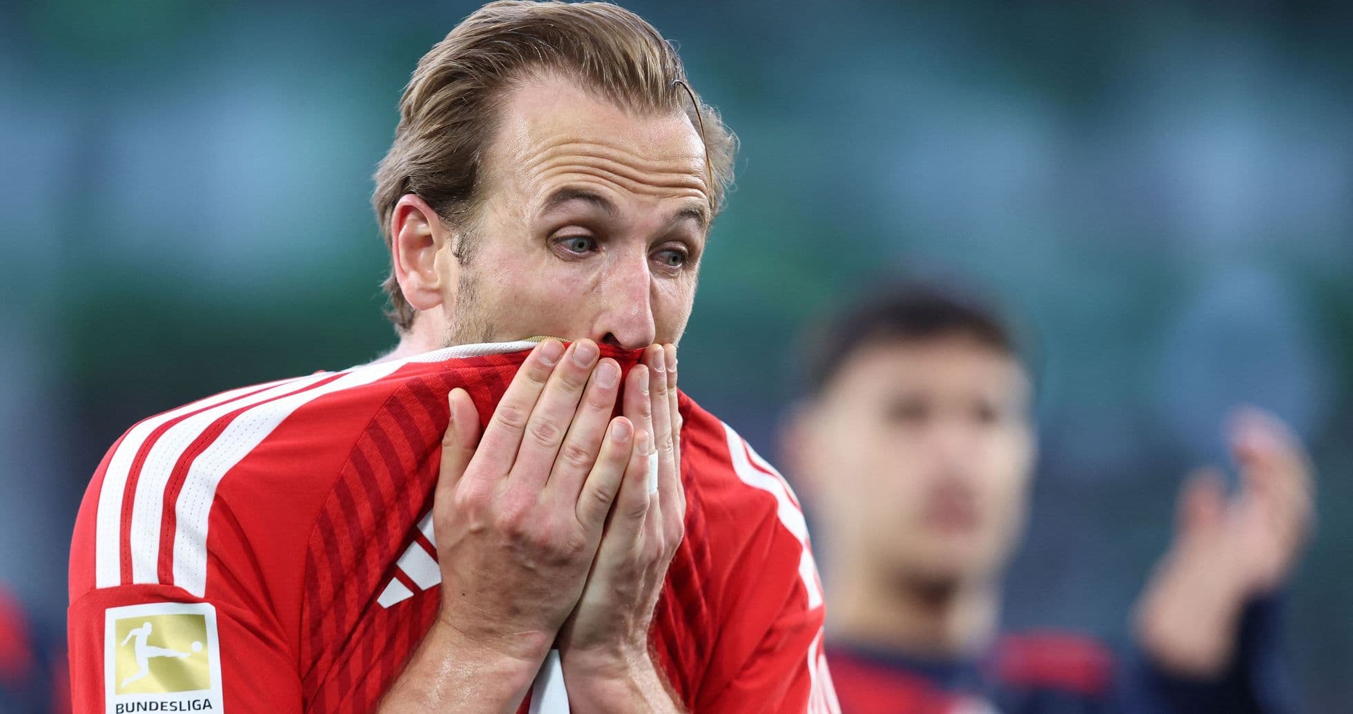 Player covering face with jersey during match Player covering face with jersey during match