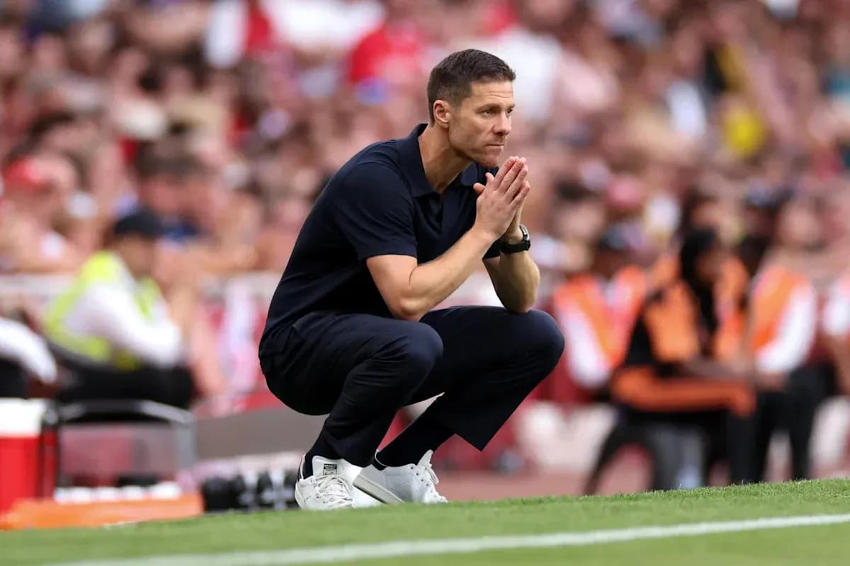 Coach kneeling on sidelines during a match Coach kneeling on sidelines during a match