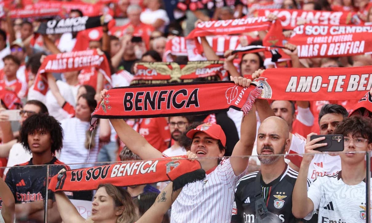 Benfica fans cheering with scarves during match Benfica fans cheering with scarves during match