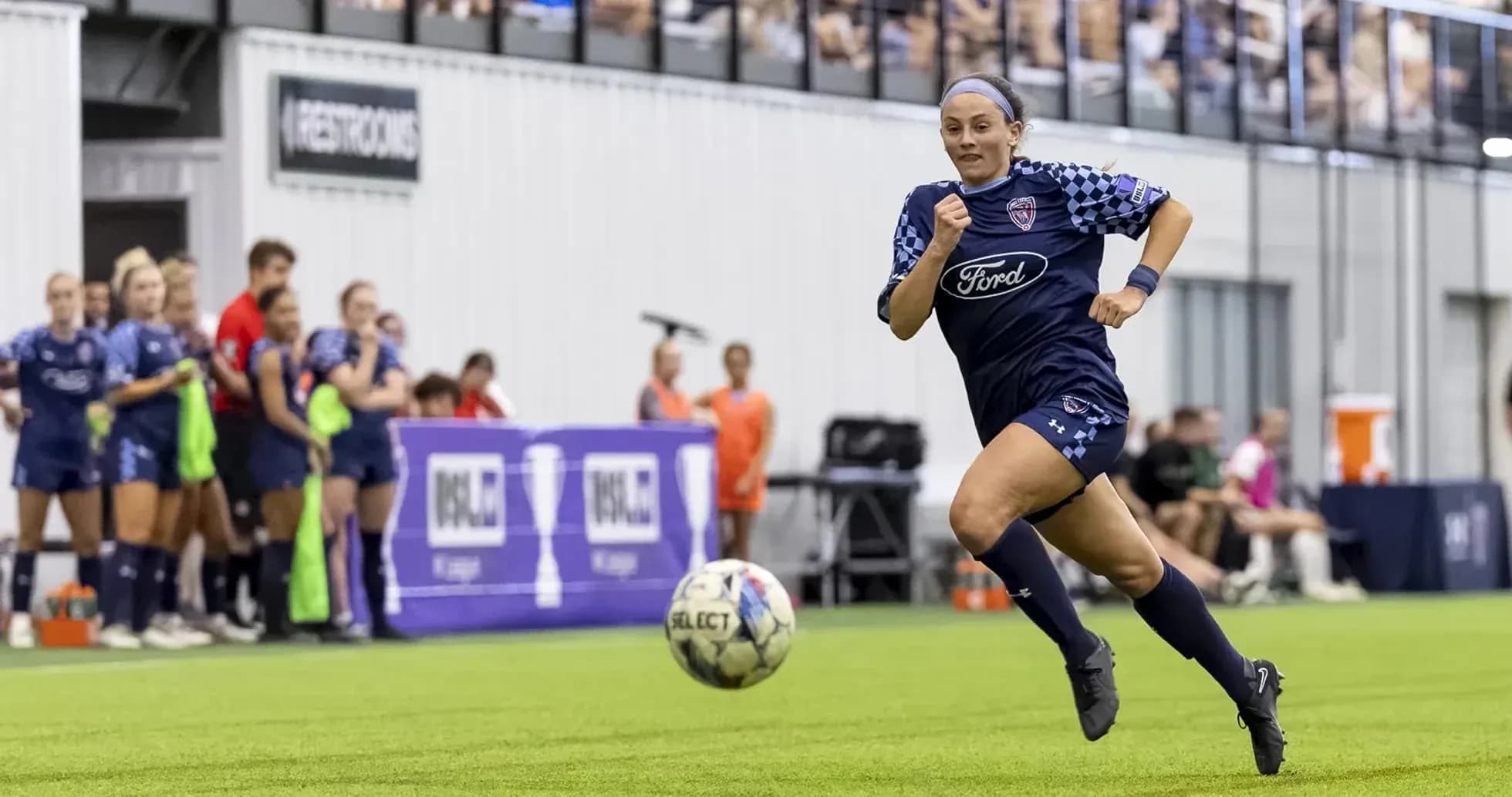 Player running with ball during USL match Player running with ball during USL match