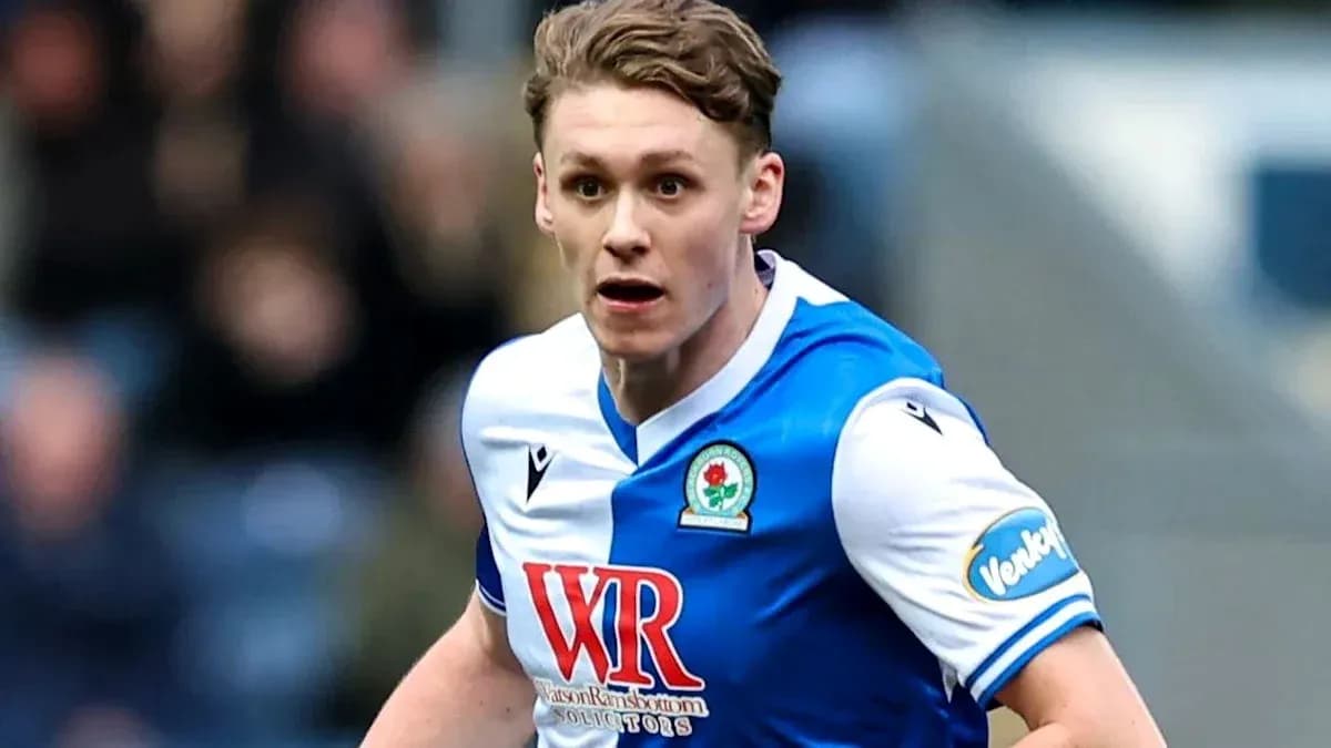 Player running on the pitch in Blackburn Rovers kit Player running on the pitch in Blackburn Rovers kit