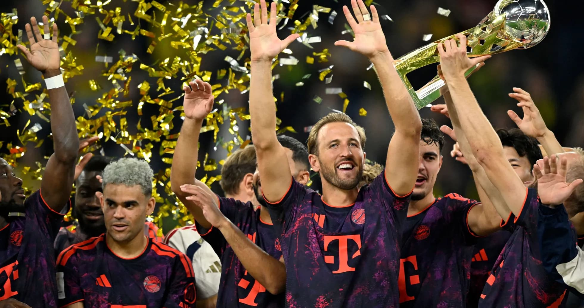 Bayern Munich players celebrating with trophy and confetti Bayern Munich players celebrating with trophy and confetti