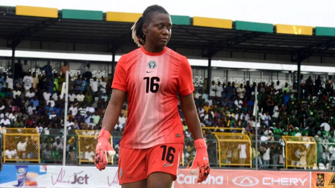 Goalkeeper in red uniform walking on field Goalkeeper in red uniform walking on field