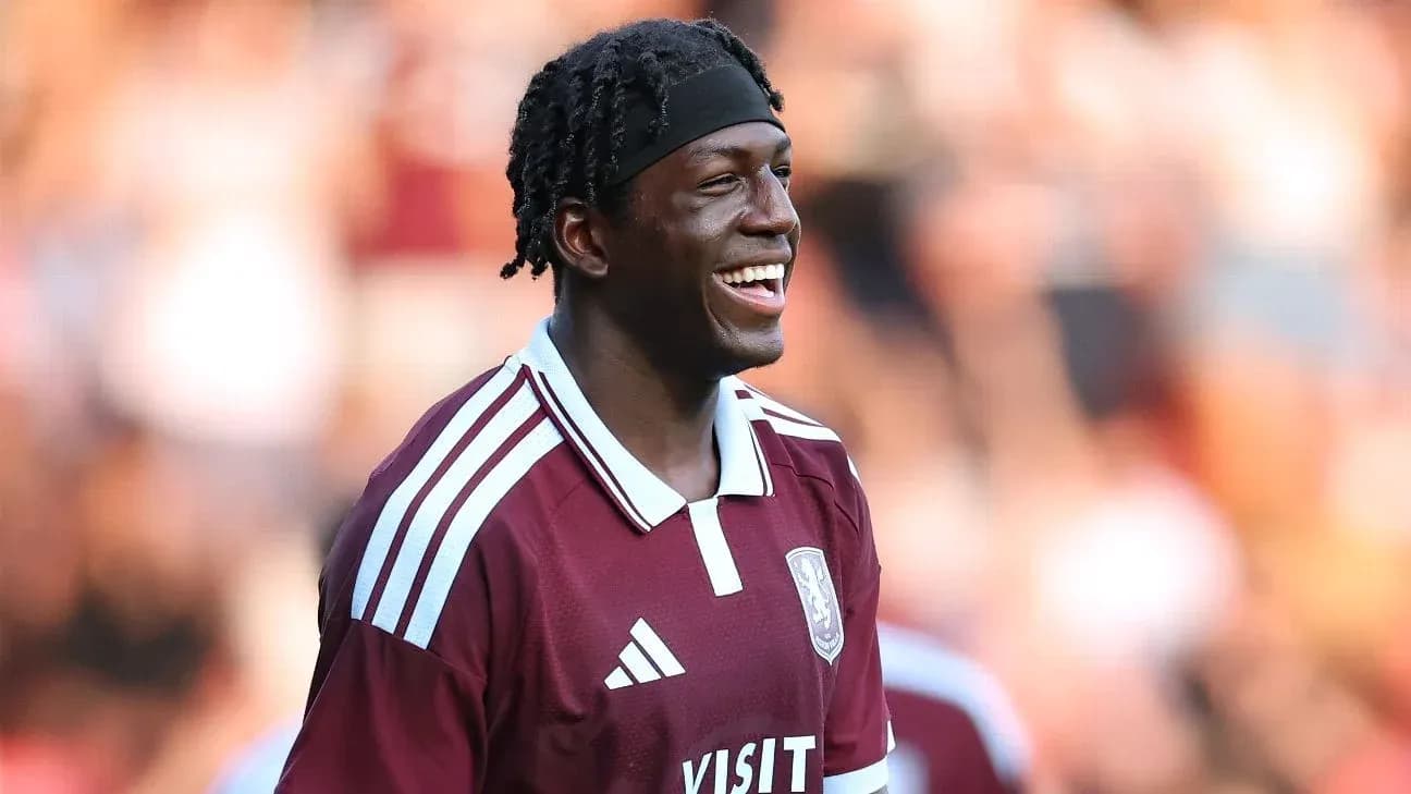 Player smiling in maroon team jersey during match Player smiling in maroon team jersey during match
