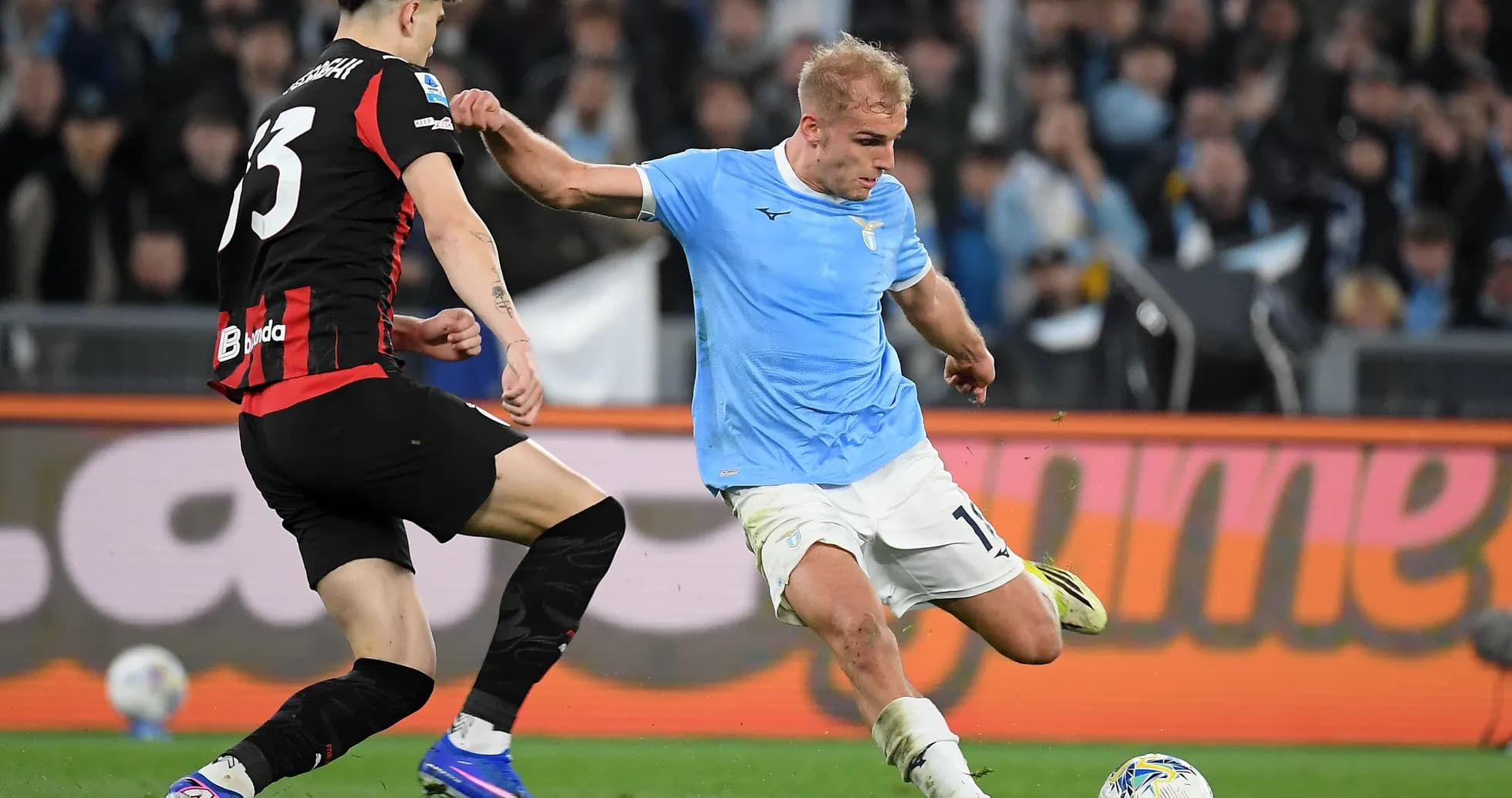 Lazio player dribbling against AC Milan defender Lazio player dribbling against AC Milan defender