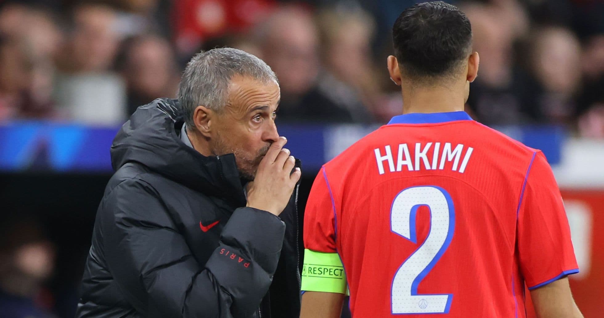 Coach giving instructions to player Hakimi on pitch Coach giving instructions to player Hakimi on pitch