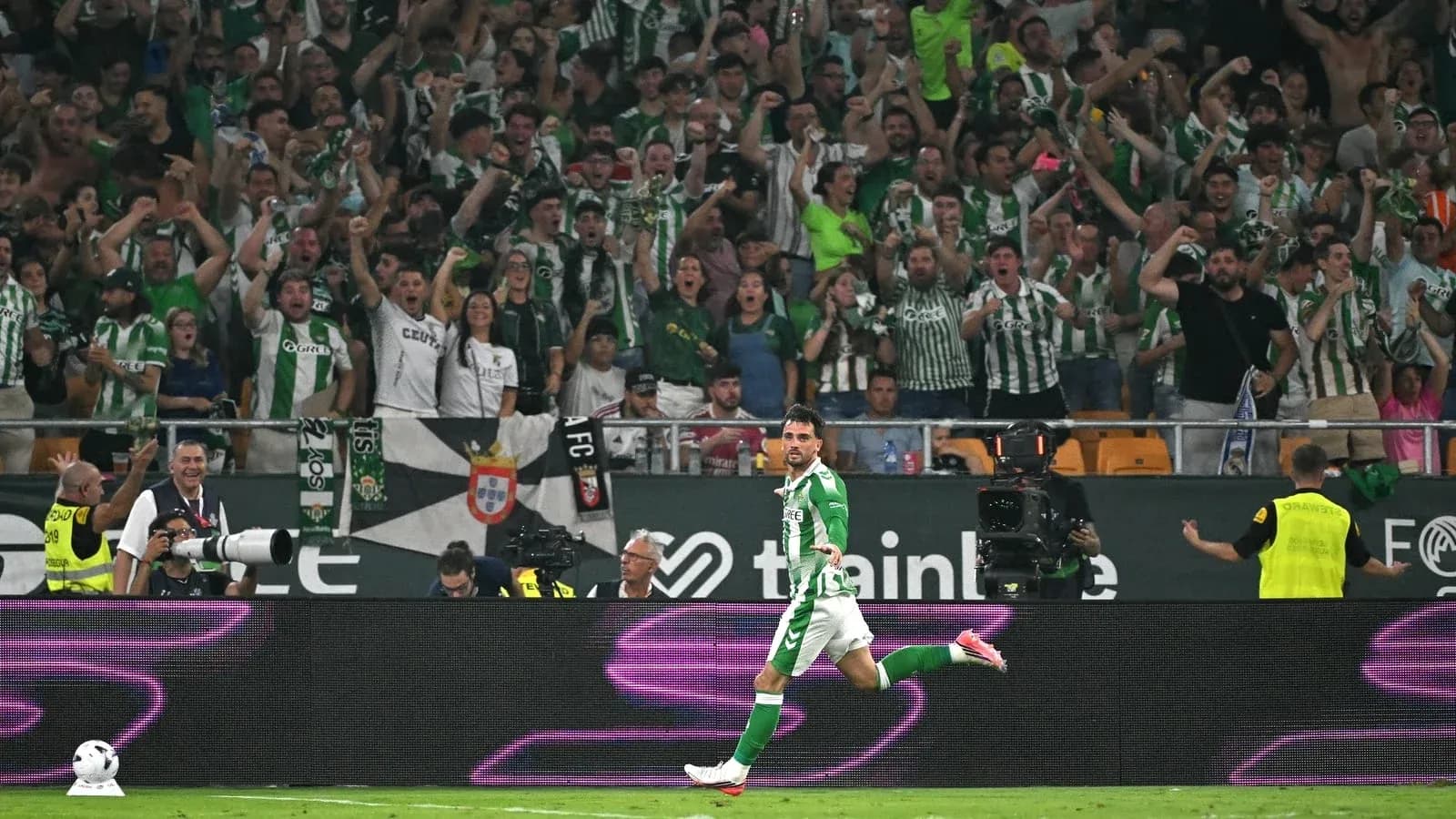 Player celebrating goal in front of cheering fans Player celebrating goal in front of cheering fans