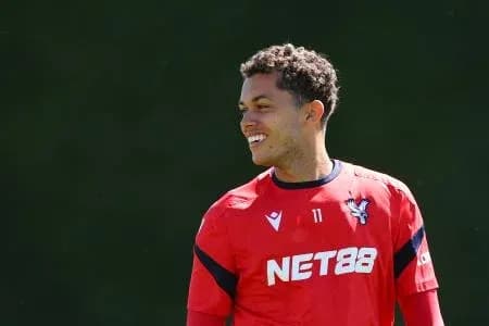 Player smiling during training session in red jersey Player smiling during training session in red jersey