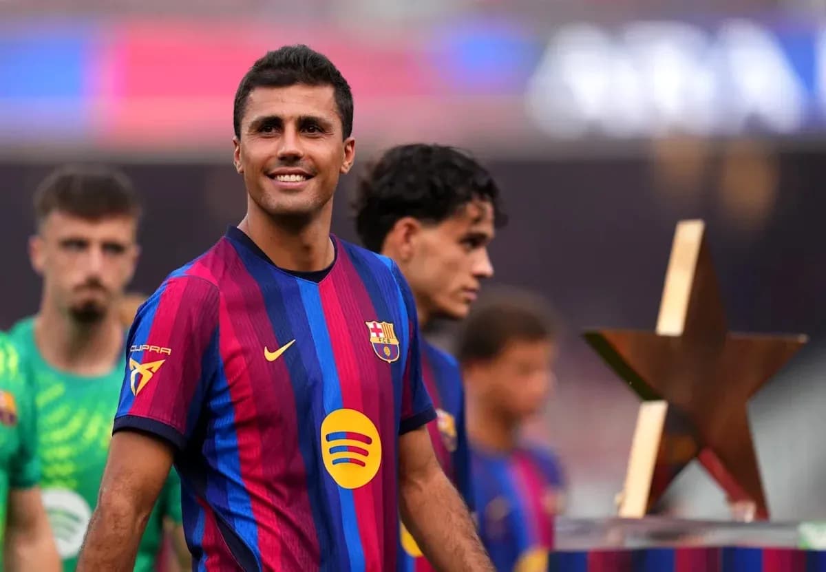 Player smiling with teammates and trophy at event Player smiling with teammates and trophy at event