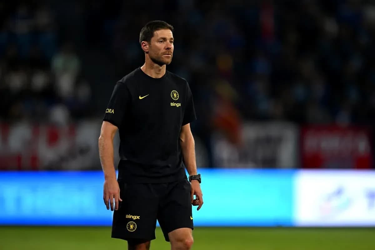 Coach walking on the pitch during a match Coach walking on the pitch during a match