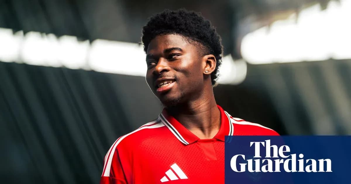 Player wearing red jersey smiling during photoshoot Player wearing red jersey smiling during photoshoot
