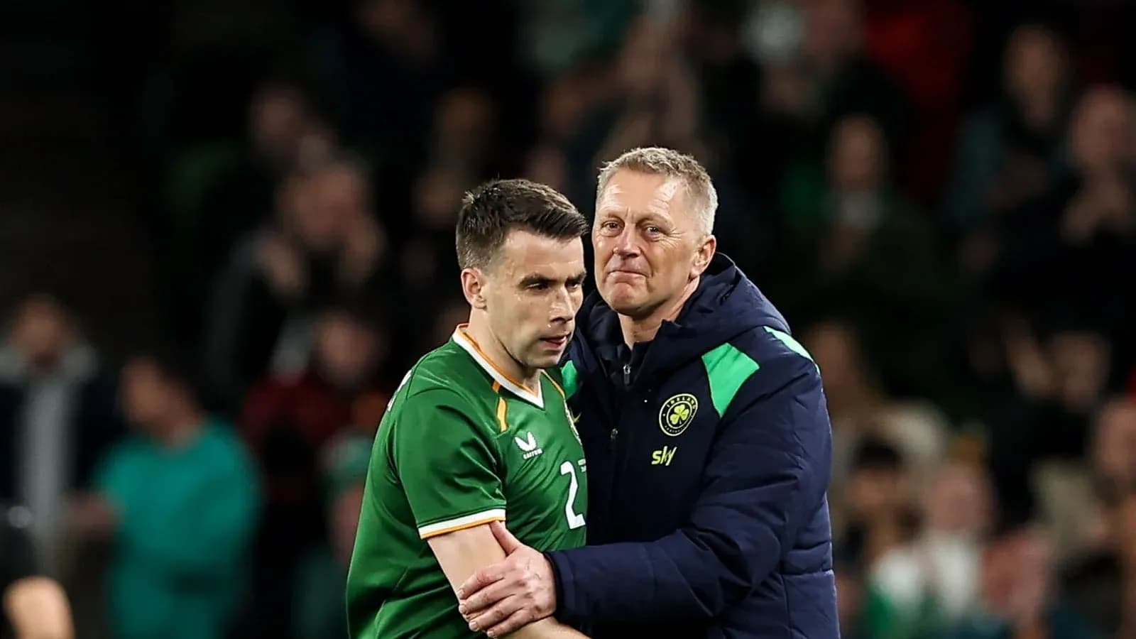 Player receiving support from coach after match Player receiving support from coach after match