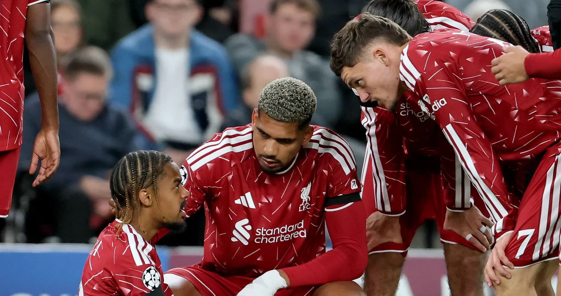 Liverpool players discussing strategy during match break Liverpool players discussing strategy during match break