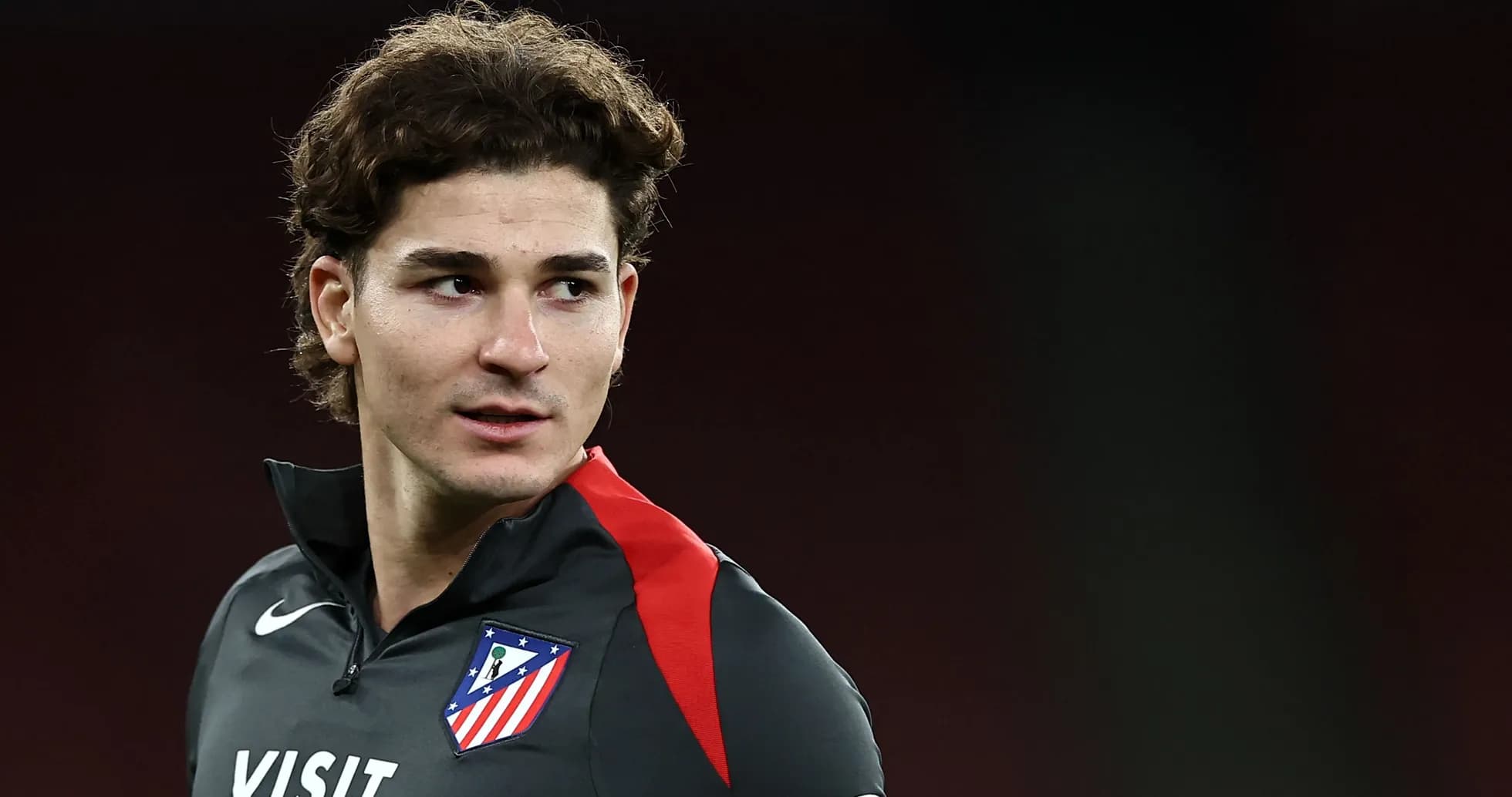 Player in Atlético Madrid training gear looking off Player in Atlético Madrid training gear looking off