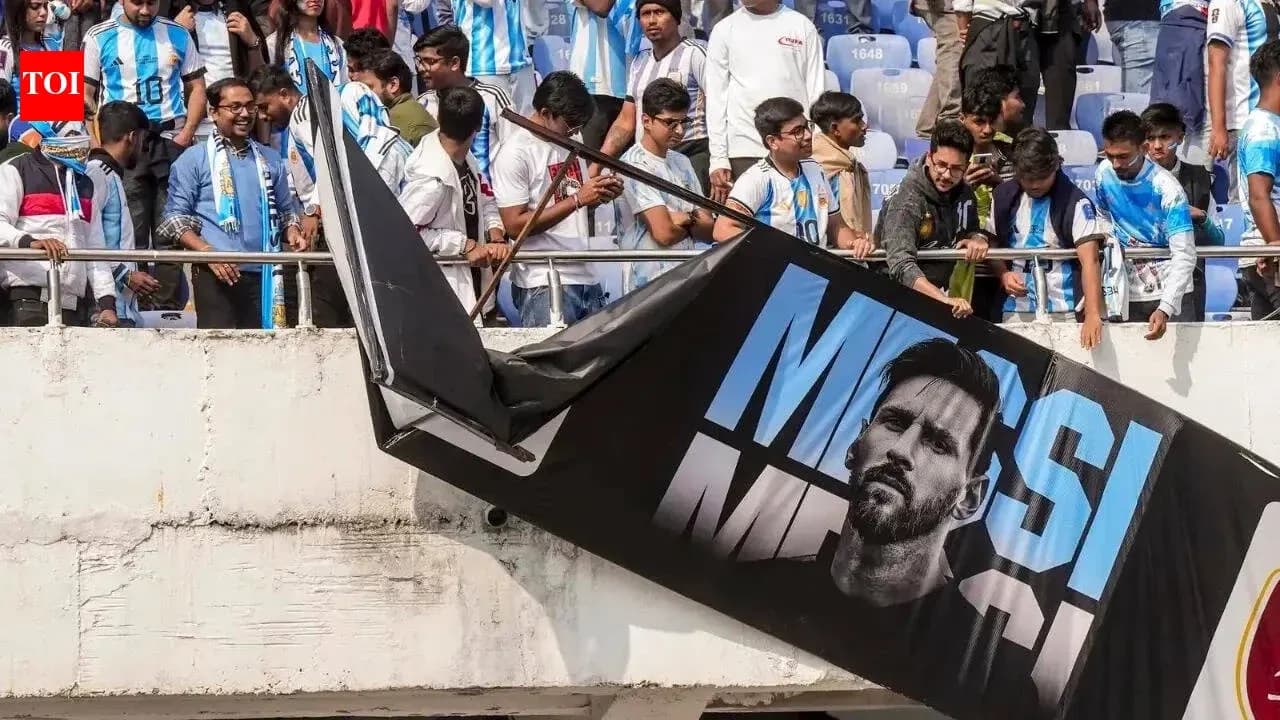 Fans with Argentina jerseys near Messi banner Fans with Argentina jerseys near Messi banner
