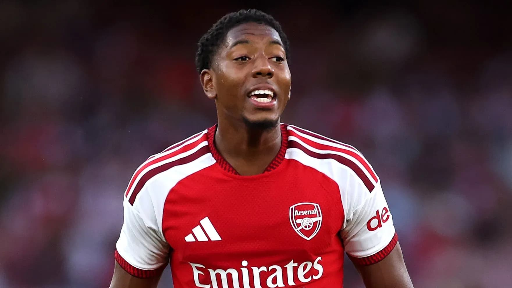 Player celebrating in Arsenal's red jersey Player celebrating in Arsenal's red jersey