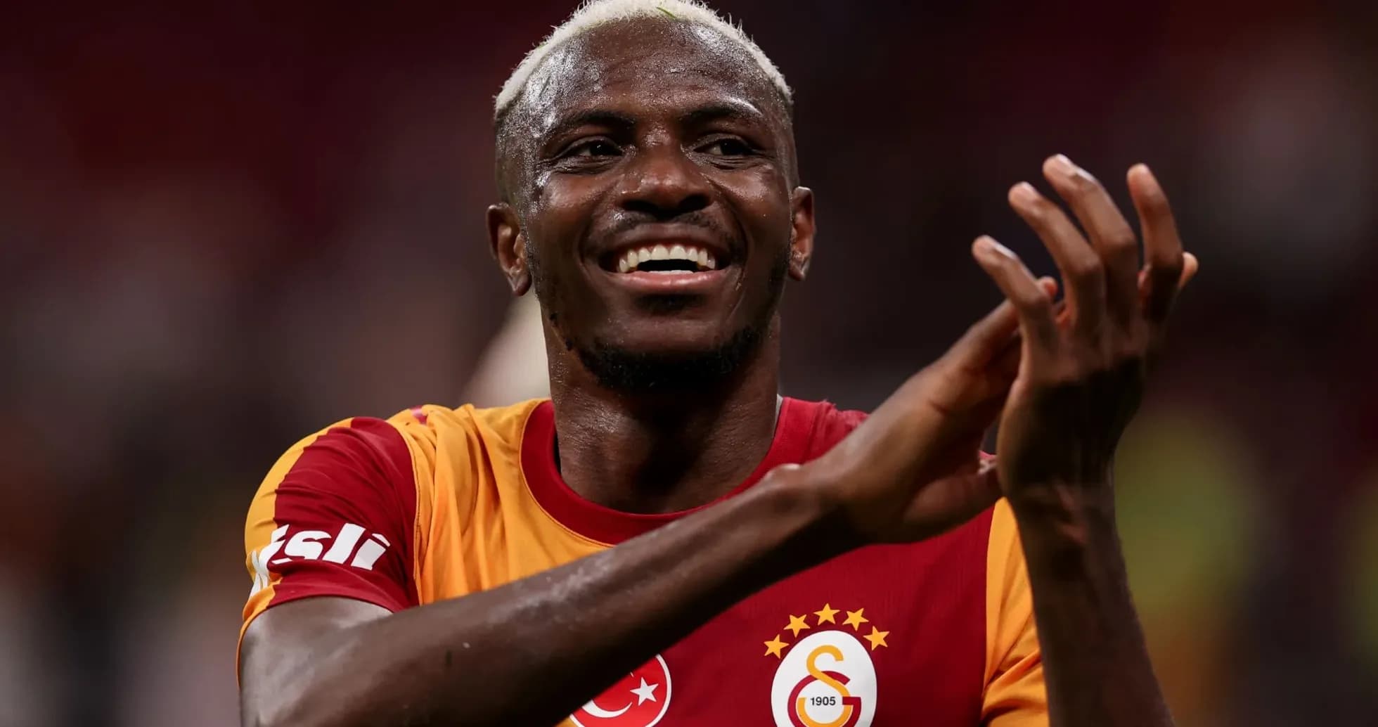 Player celebrating in Galatasaray jersey on field Player celebrating in Galatasaray jersey on field