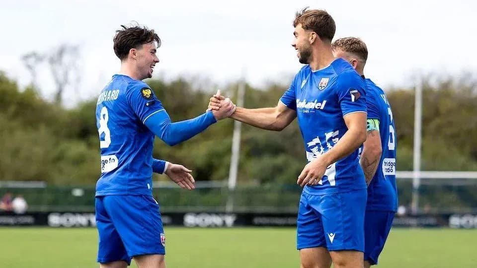 Two players celebrating a goal with a handshake Two players celebrating a goal with a handshake