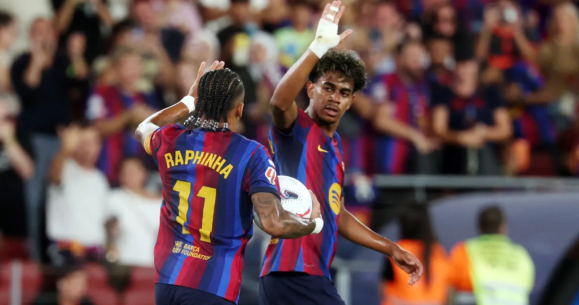 Raphinha celebrating with teammate during match Raphinha celebrating with teammate during match
