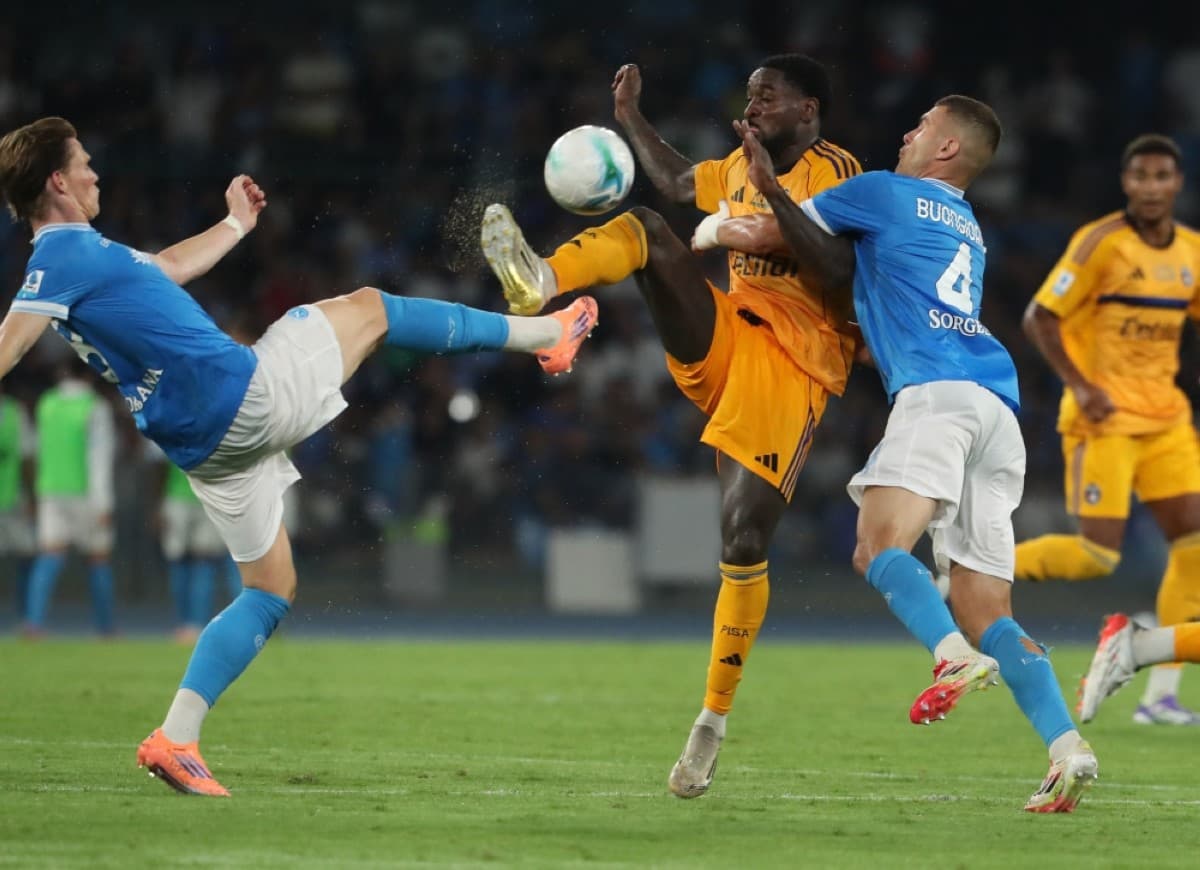 Pisa player tackles Napoli opponent during match Pisa player tackles Napoli opponent during match