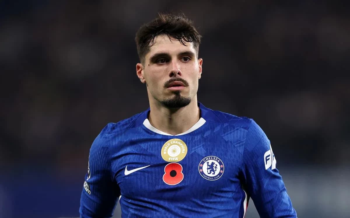 Player in blue Chelsea kit on the field Player in blue Chelsea kit on the field