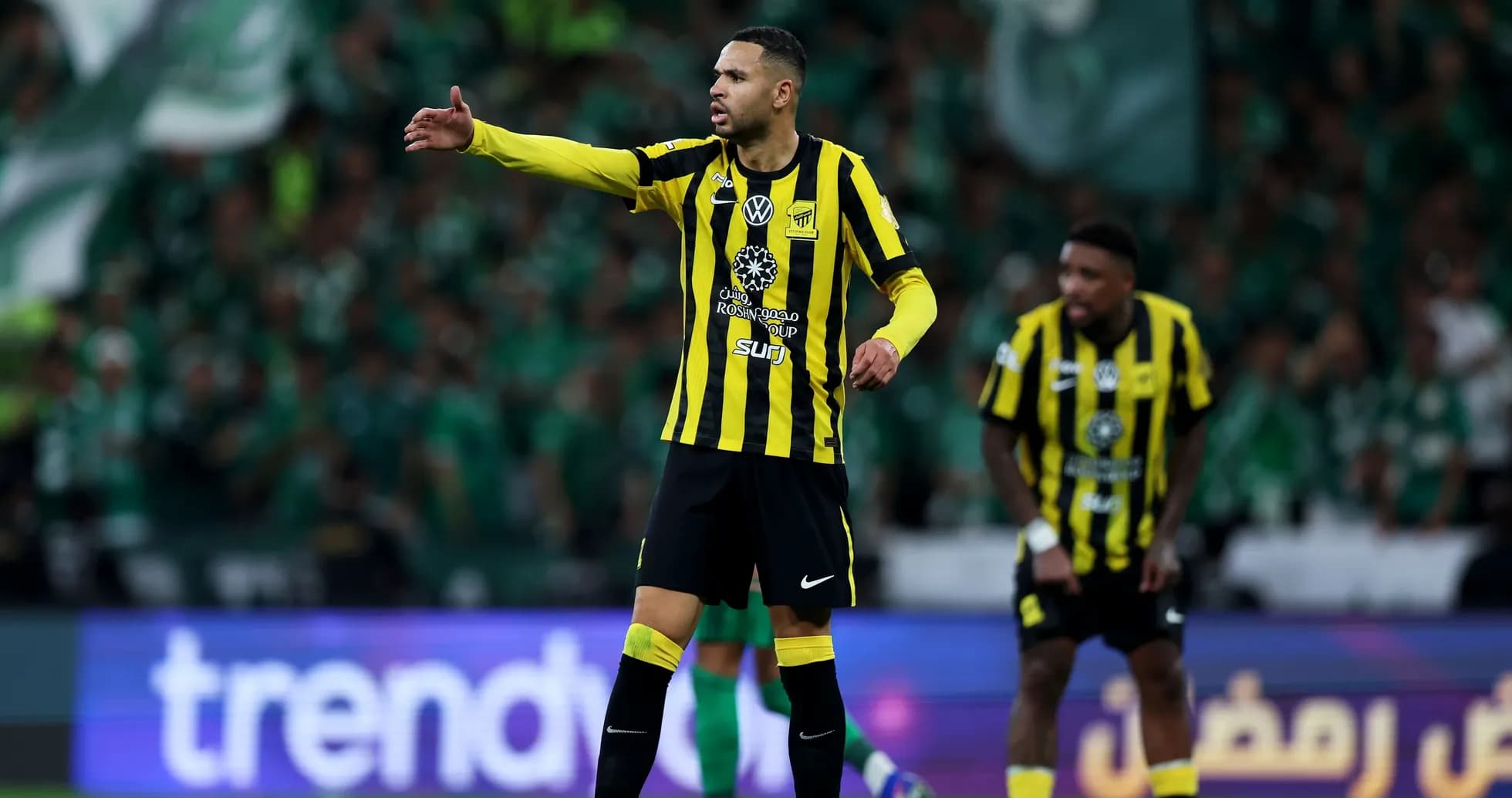 Player directing teammates during a football match Player directing teammates during a football match