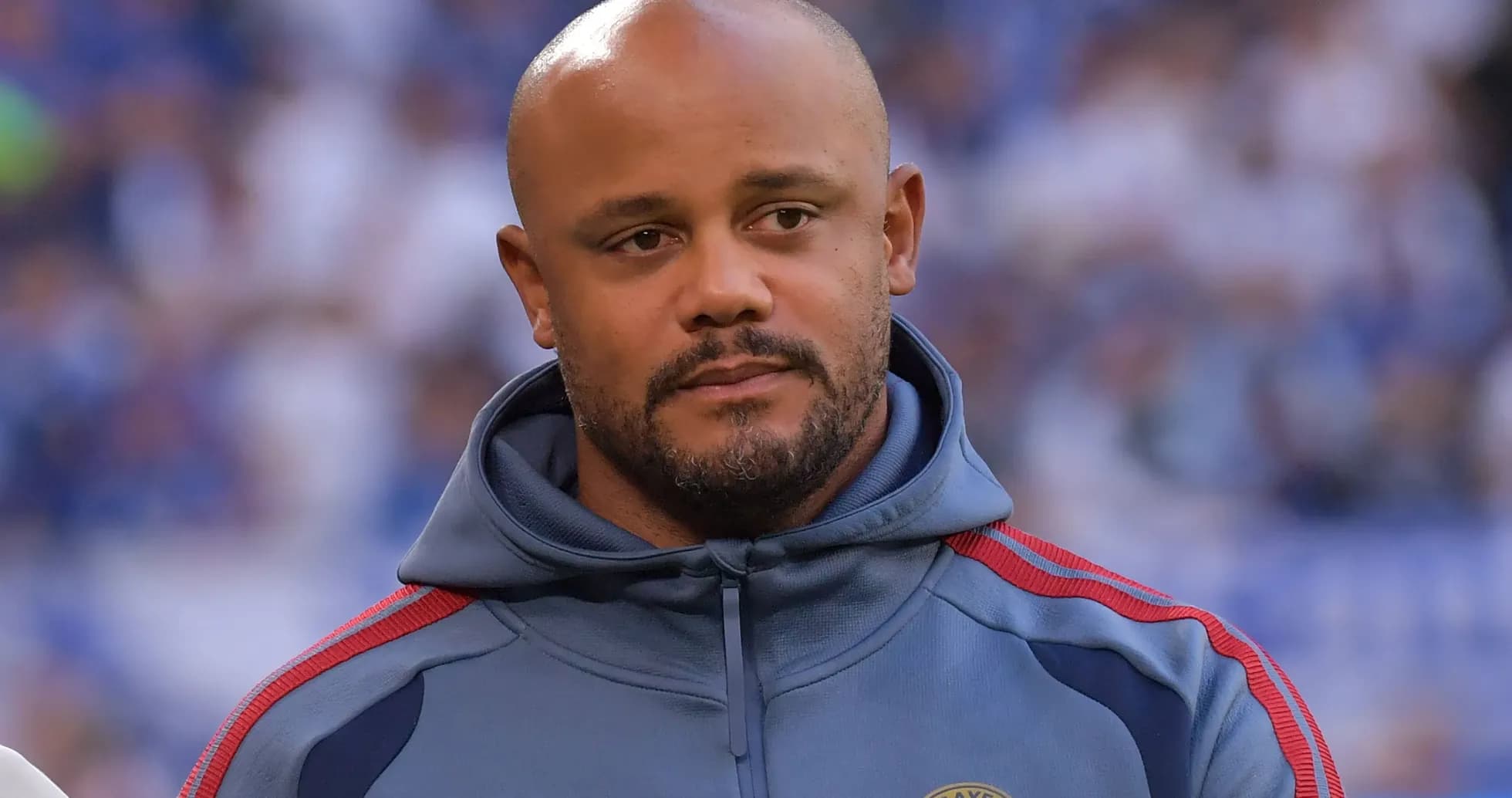 Man in a gray hoodie with team logo Man in a gray hoodie with team logo