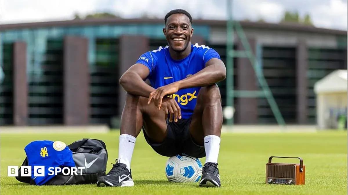 Player sitting on field with soccer ball and bag Player sitting on field with soccer ball and bag