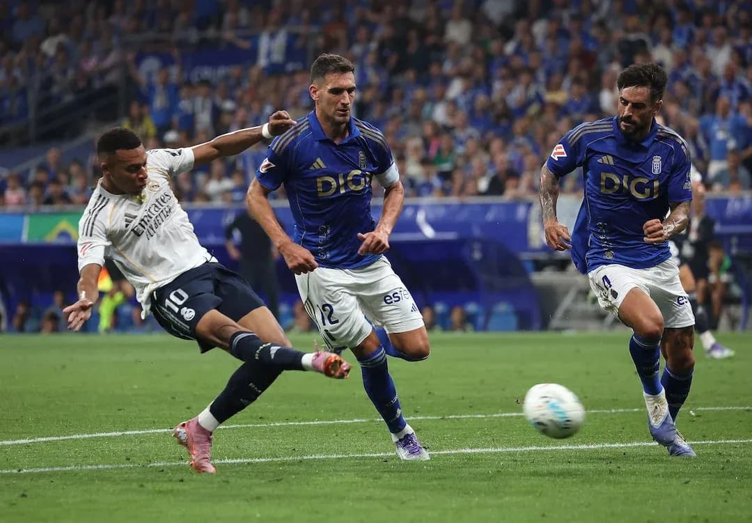 Real Madrid player attempts to shoot on goal Real Madrid player attempts to shoot on goal